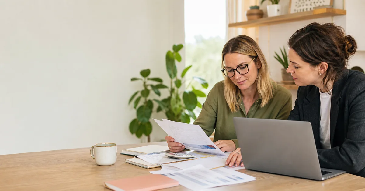 Victorian small-business owner reviewing bookkeeping records with a bookkeeper for BAS lodgement and compliance support